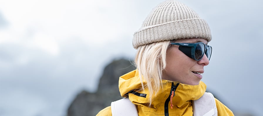 Mountaineer woman wearing Smith Venture Sunglasses and a yellow jacket