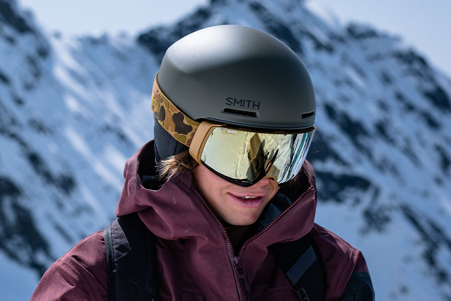 Skier wearing Smith snow helmet and goggles