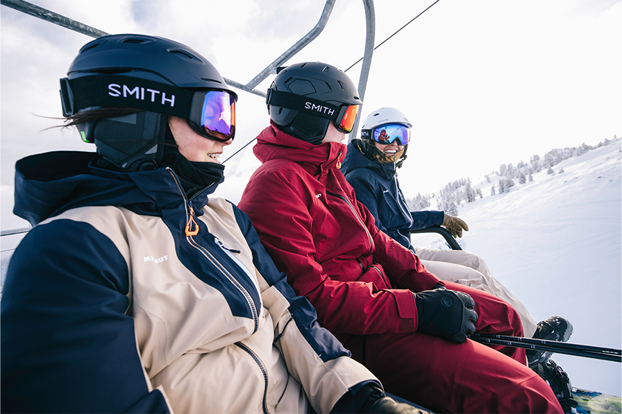 People on ski lift wearing Smith Helmets