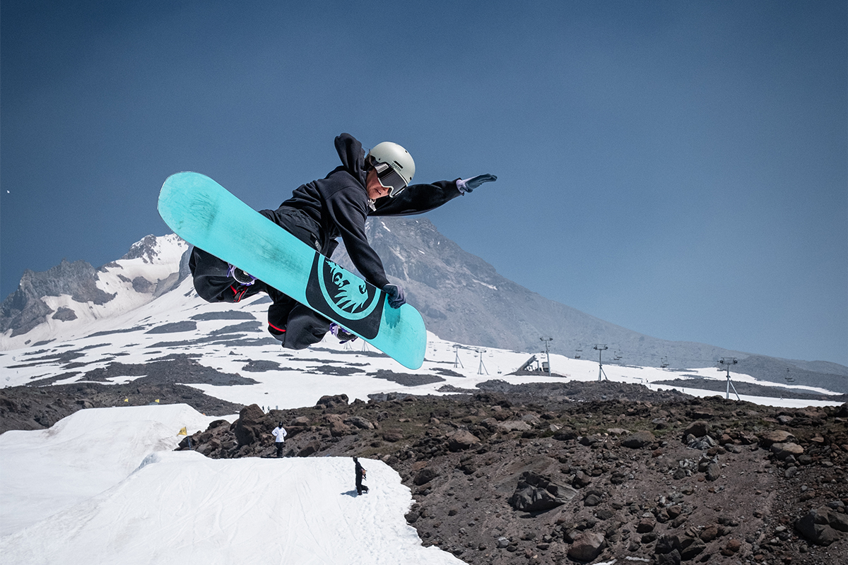 Zeb Powell doing a deep toe side carve while wearing the Smith Rodeo Mips Snow Helmet