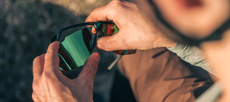 Person changing lenses out on Motive sunglasses