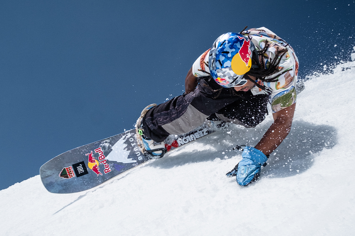 Zeb Powell doing a deep toe side carve while wearing the Smith Rodeo Mips Snow Helmet