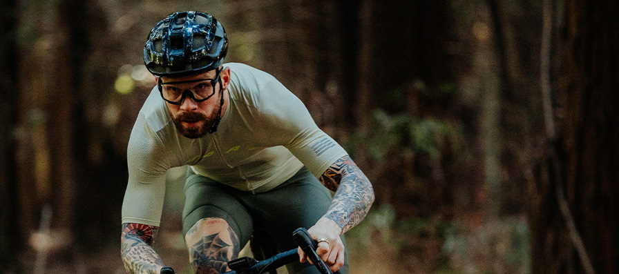 Gravel cyclist wearing Smith Wildcat sunglasses and Trace helmet