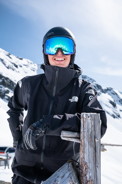 Skier holding skis over their shoulder while wearing Smith 4D MAG XL goggles and the Method Pro Helmet