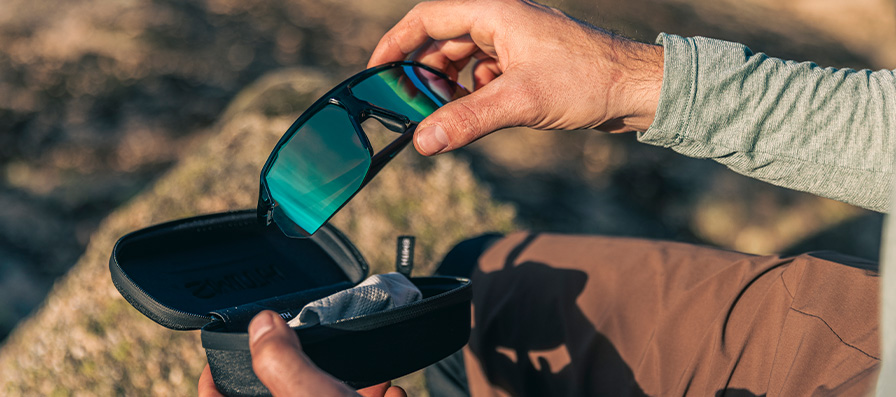 Person taking Motive sunglasses out of case